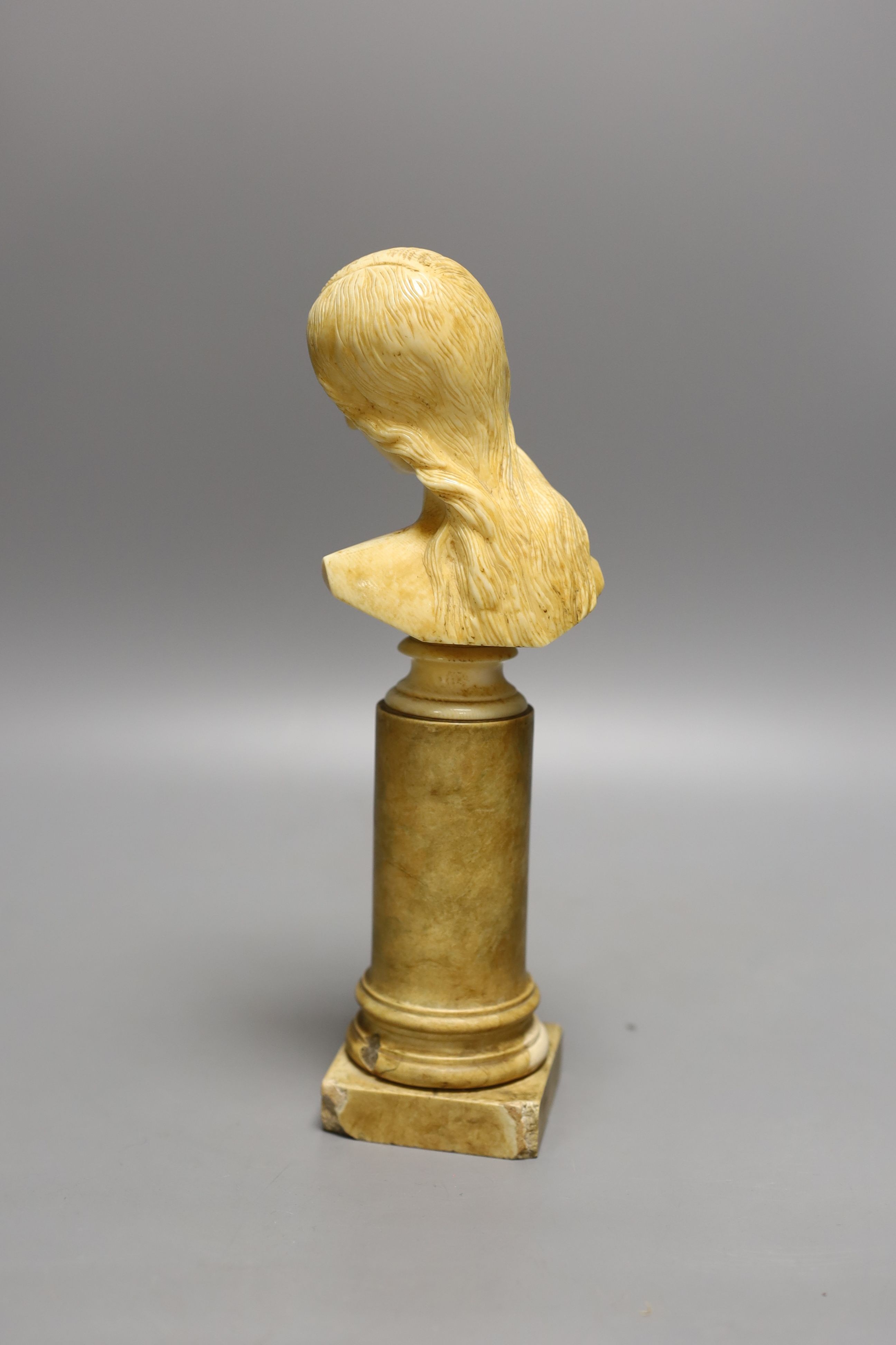 An 18th/19th century grand tour ivory bust of a lady on a Siena marble pedestal, 24cm